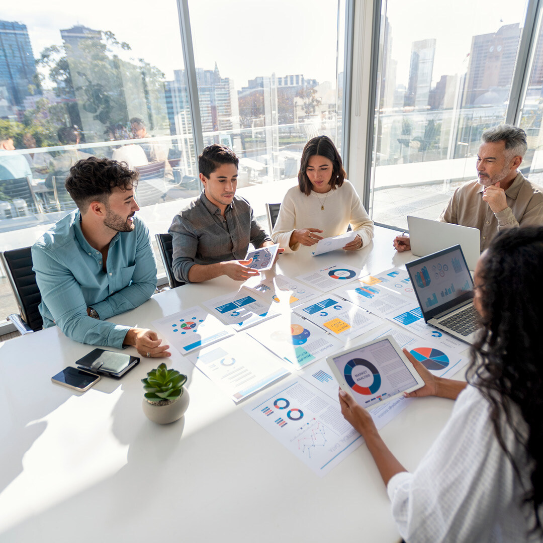 Group of coworkers looking at graphs