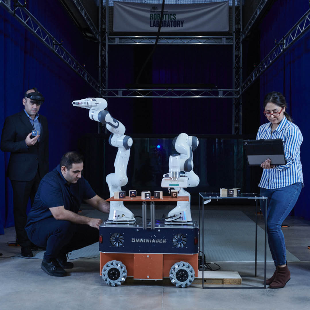 three people with robotics machine